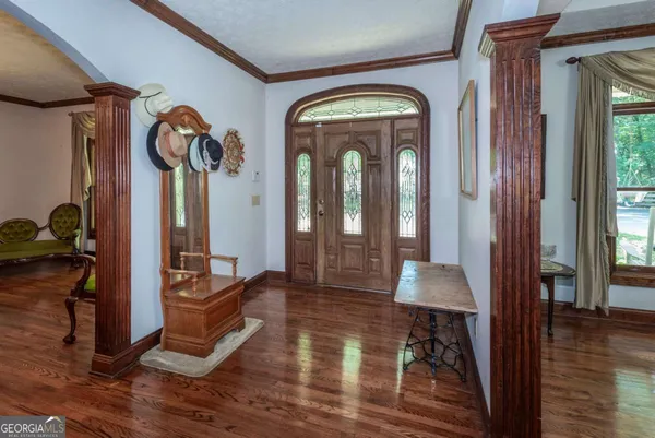 a kitchen with stainless steel appliances granite countertop a refrigerator a sink dishwasher a stove and white countertops with wooden floor