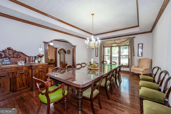 a living room with fireplace furniture and a large window