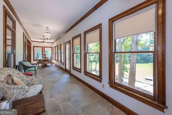 a bedroom with a bed and a table in it with wooden floor