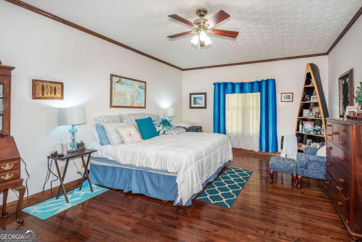 755 Harris Road Jasper, GA 30143 - Photo 37 of 62 a bedroom with a bed and a chandelier