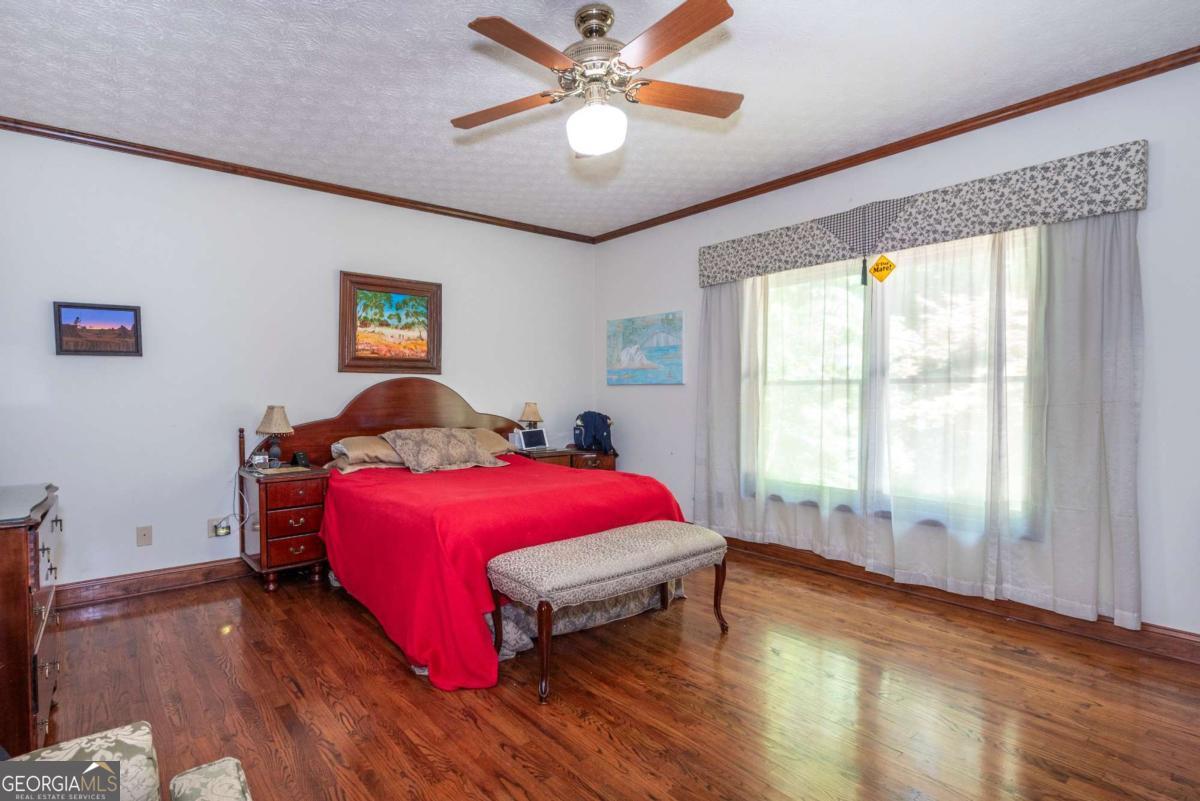 755 Harris Road Jasper, GA 30143 - Photo 38 of 62 a bedroom with a bed and a chandelier