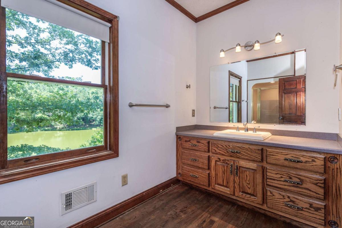755 Harris Road Jasper, GA 30143 - Photo 41 of 62 a spacious bathroom with a granite countertop sink mirror and window