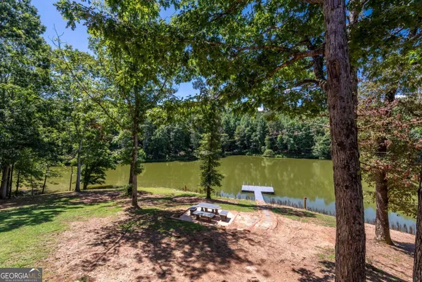 an aerial view of a house with a yard and lake view