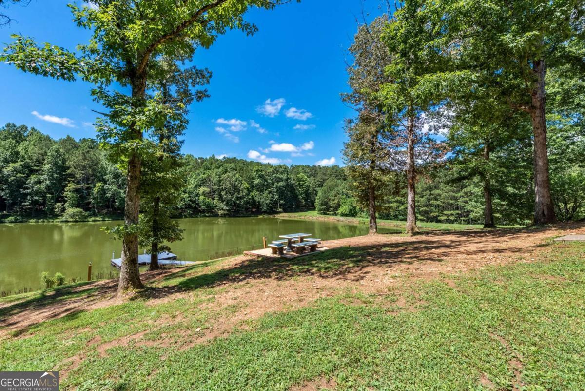 755 Harris Road Jasper, GA 30143 - Photo 47 of 62 a view of a lake with a house in the background