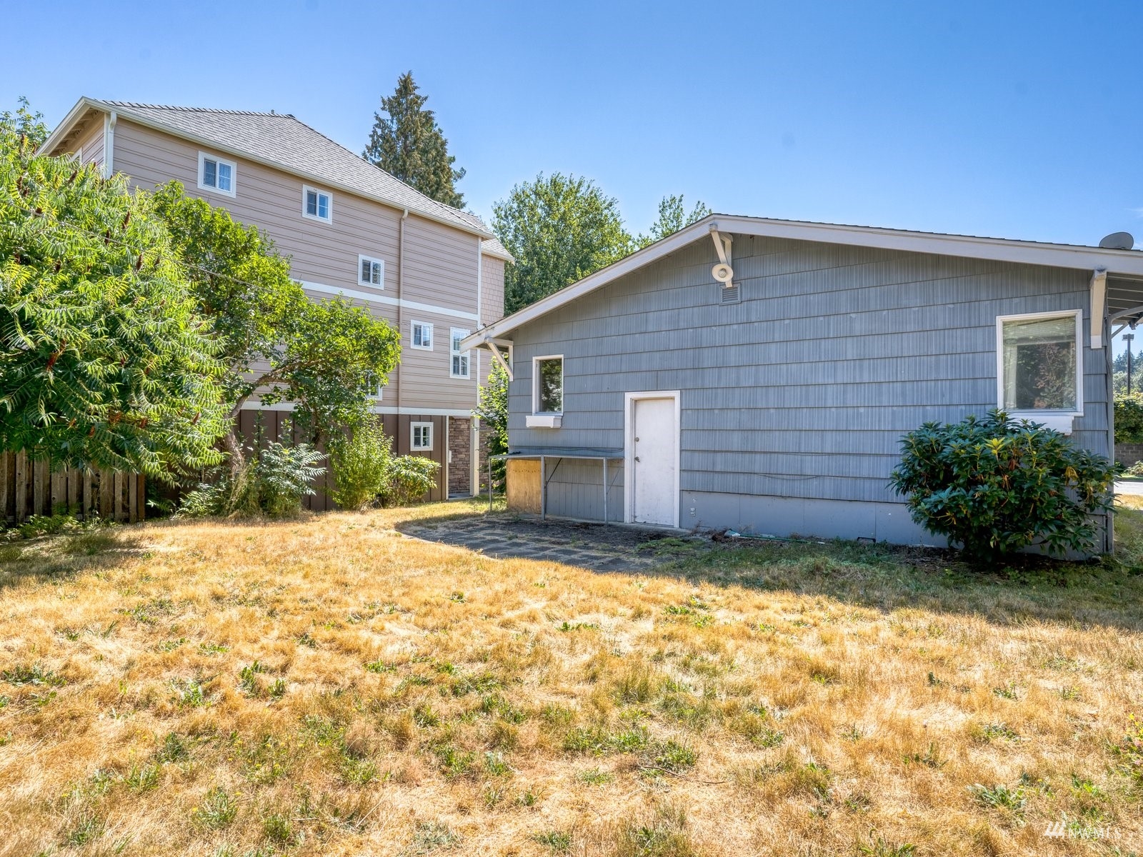 10120 Northeast 185th Street Bothell, WA 98011 - Photo 2 of 20 a view of a backyard with plants and large tree