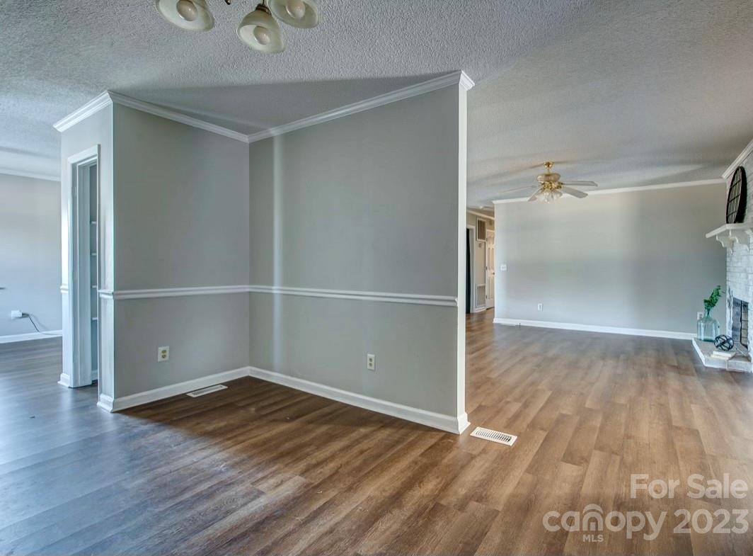 363 Griggs Road Clover, SC 29710 - Photo 11 of 26 an empty room with wooden floor and windows