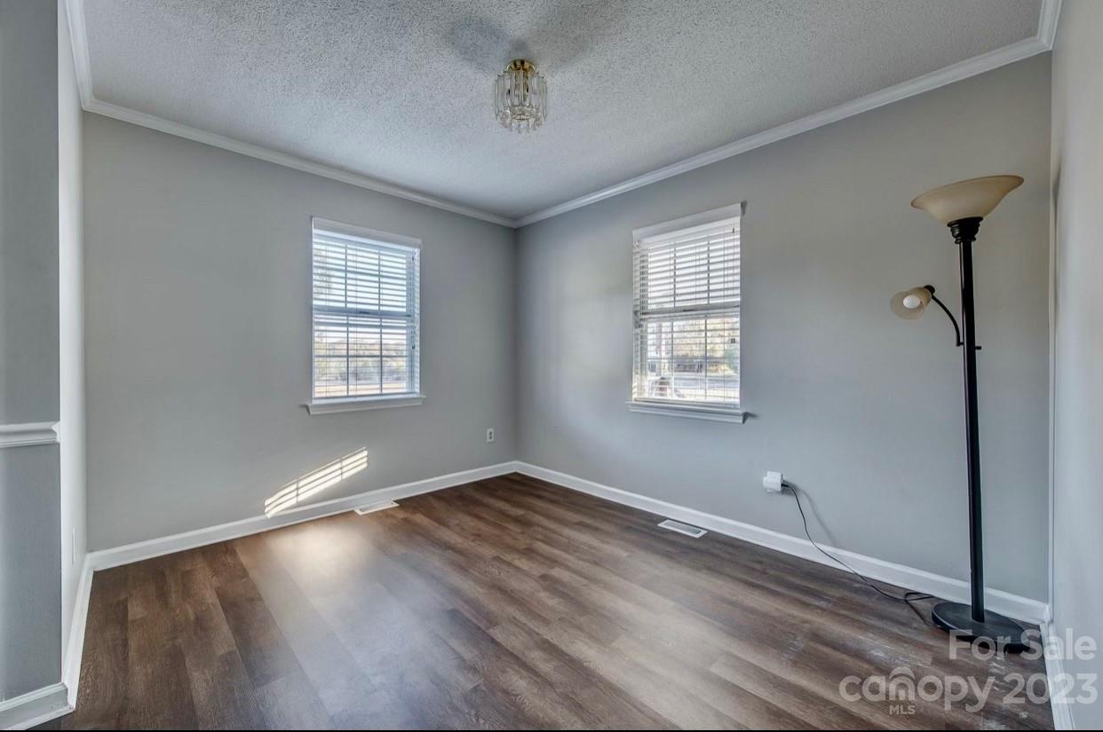 363 Griggs Road Clover, SC 29710 - Photo 12 of 26 an empty room with wooden floor and windows
