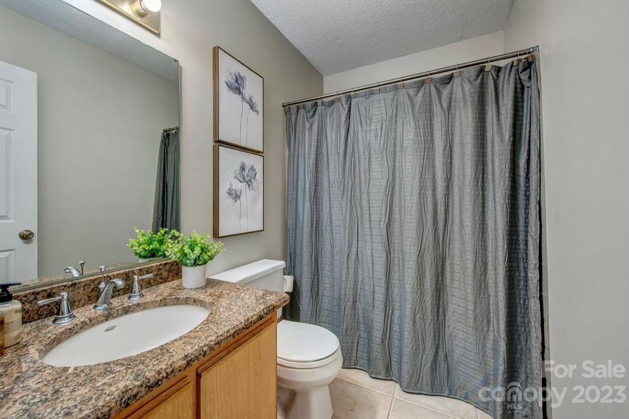 363 Griggs Road Clover, SC 29710 - Photo 19 of 26 a bathroom with a granite countertop sink toilet and mirror