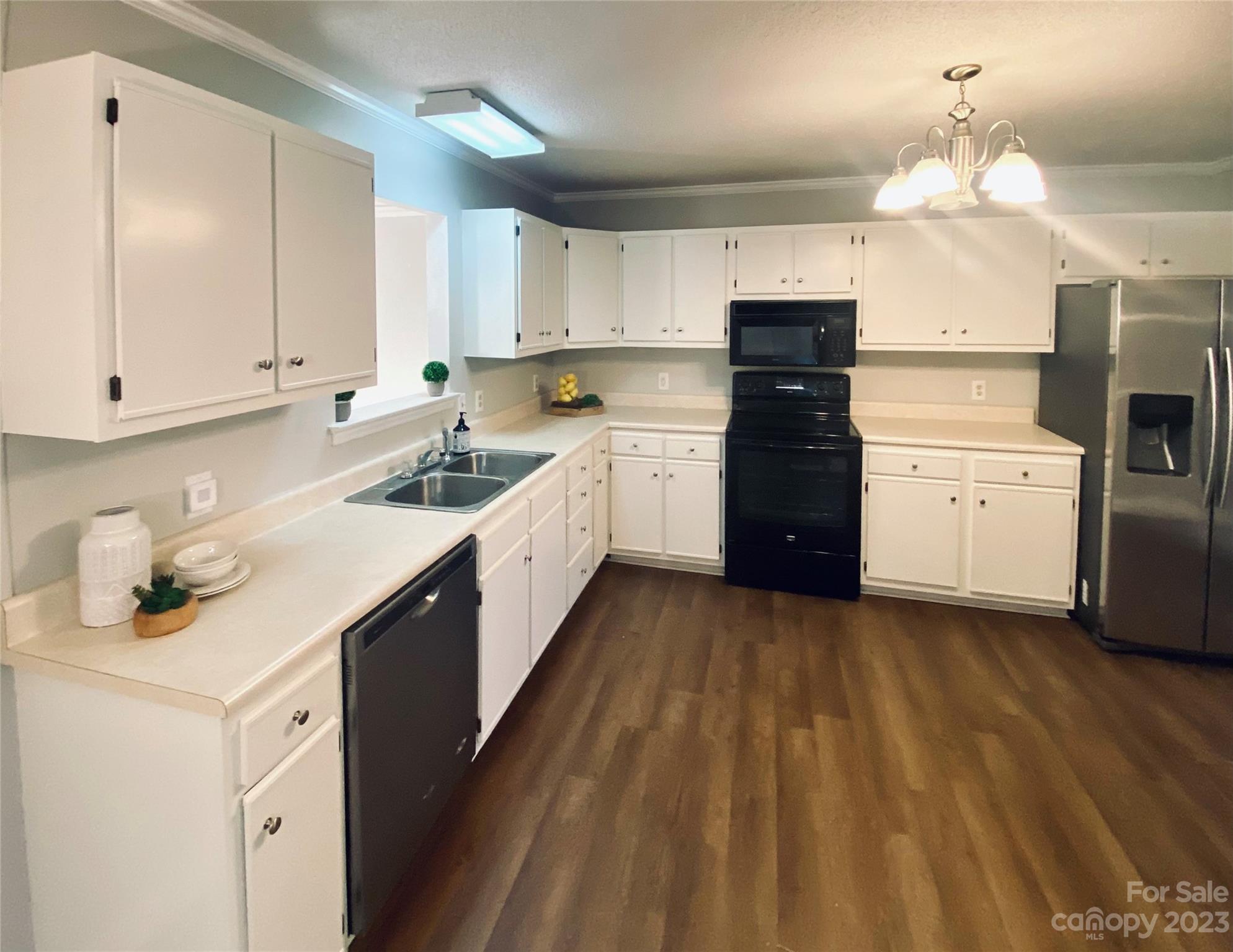 363 Griggs Road Clover, SC 29710 - Photo 10 of 26 a kitchen with a sink dishwasher a stove a refrigerator and cabinets