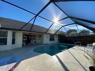 a view of a patio with a table and chairs under an umbrella