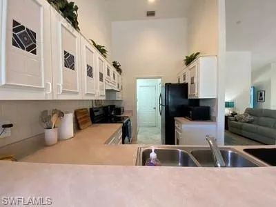a kitchen with a sink and a refrigerator