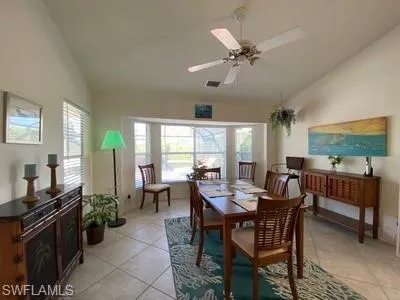 a view of a dining room with furniture and a chandelier