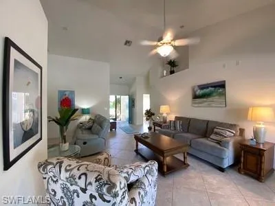 a living room with furniture flower pot and a chandelier