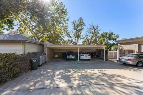 a view of a house with a patio and a yard