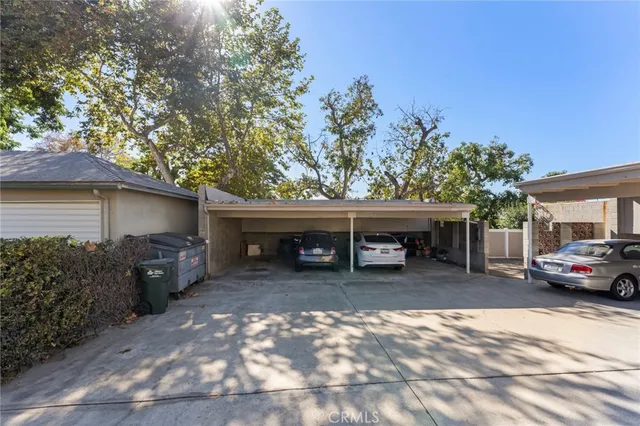 a view of a house with a patio and a yard