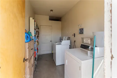 a view of storage and utility room with washer and dryer