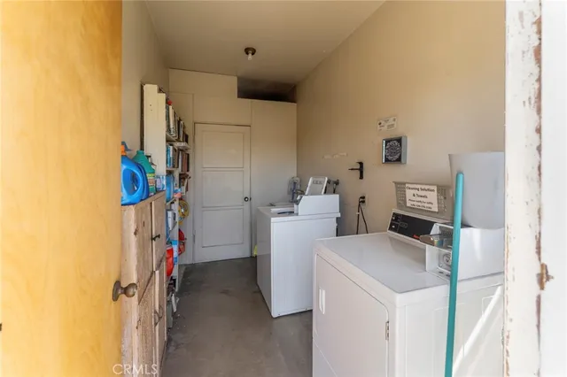 a view of storage and utility room with washer and dryer