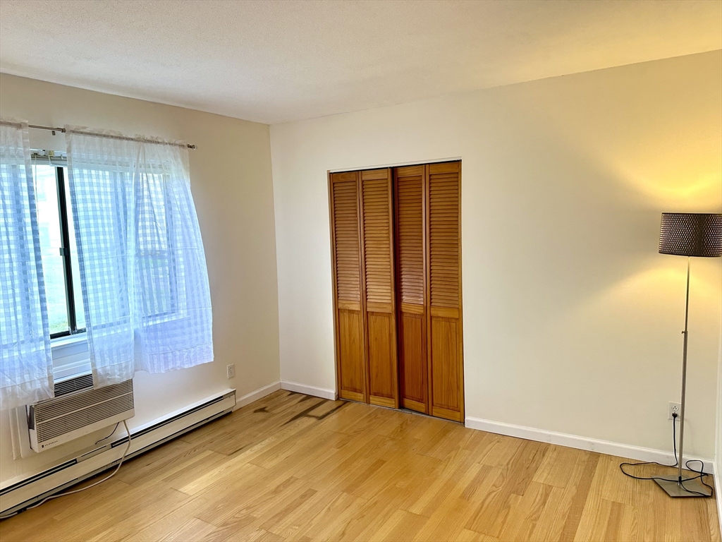 170 East Hadley Road, Unit 11 Amherst, MA 01002 - Photo 11 of 16 a view of an empty room with window