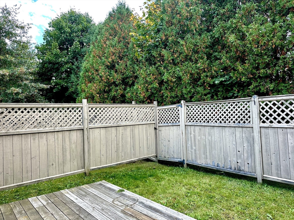170 East Hadley Road, Unit 11 Amherst, MA 01002 - Photo 15 of 16 a view of a backyard with wooden fence