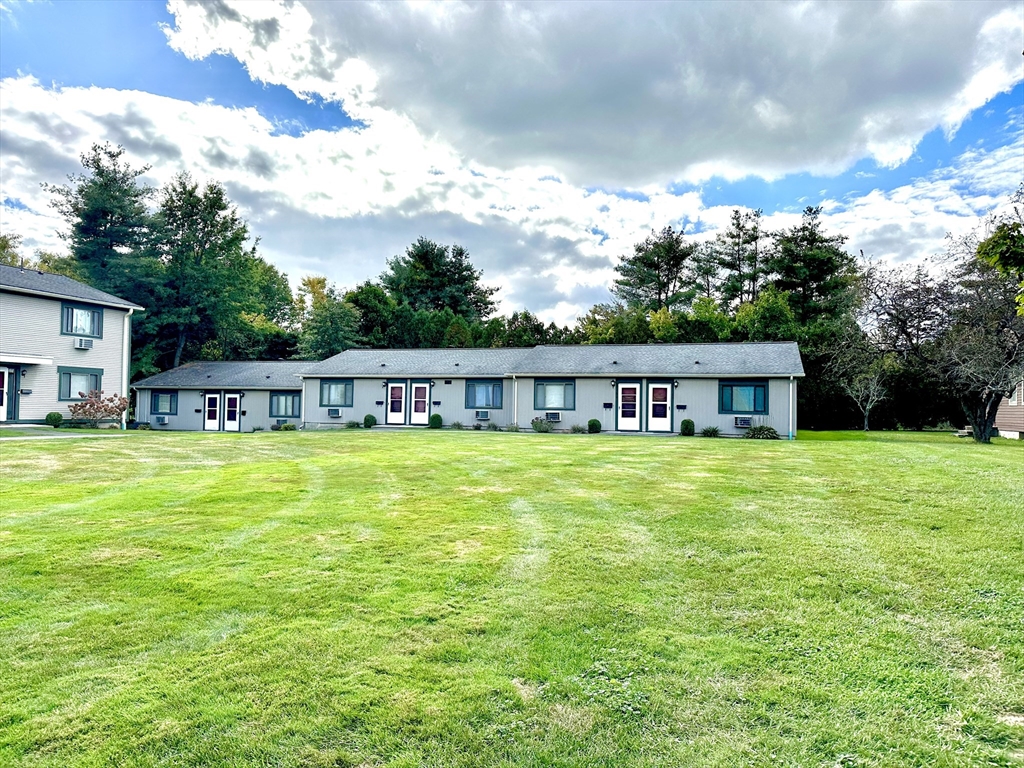170 East Hadley Road, Unit 11 Amherst, MA 01002 - Photo 3 of 16 a front view of a house with a garden