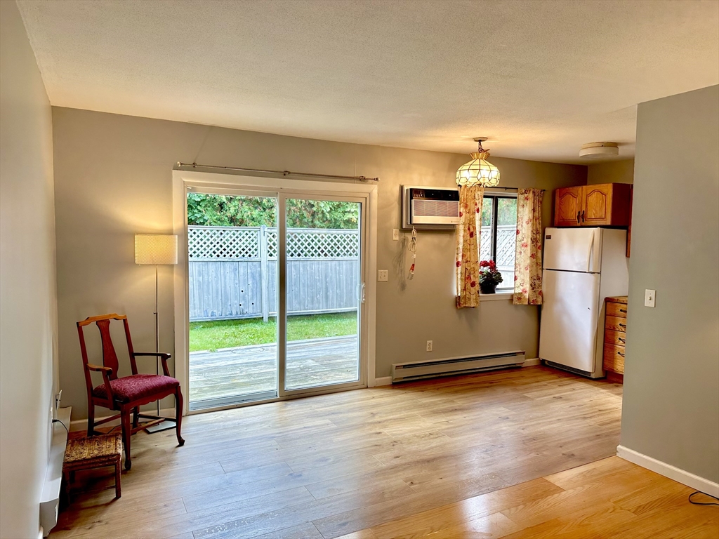 170 East Hadley Road, Unit 11 Amherst, MA 01002 - Photo 6 of 16 a view of a room with wooden floor and a refrigerator
