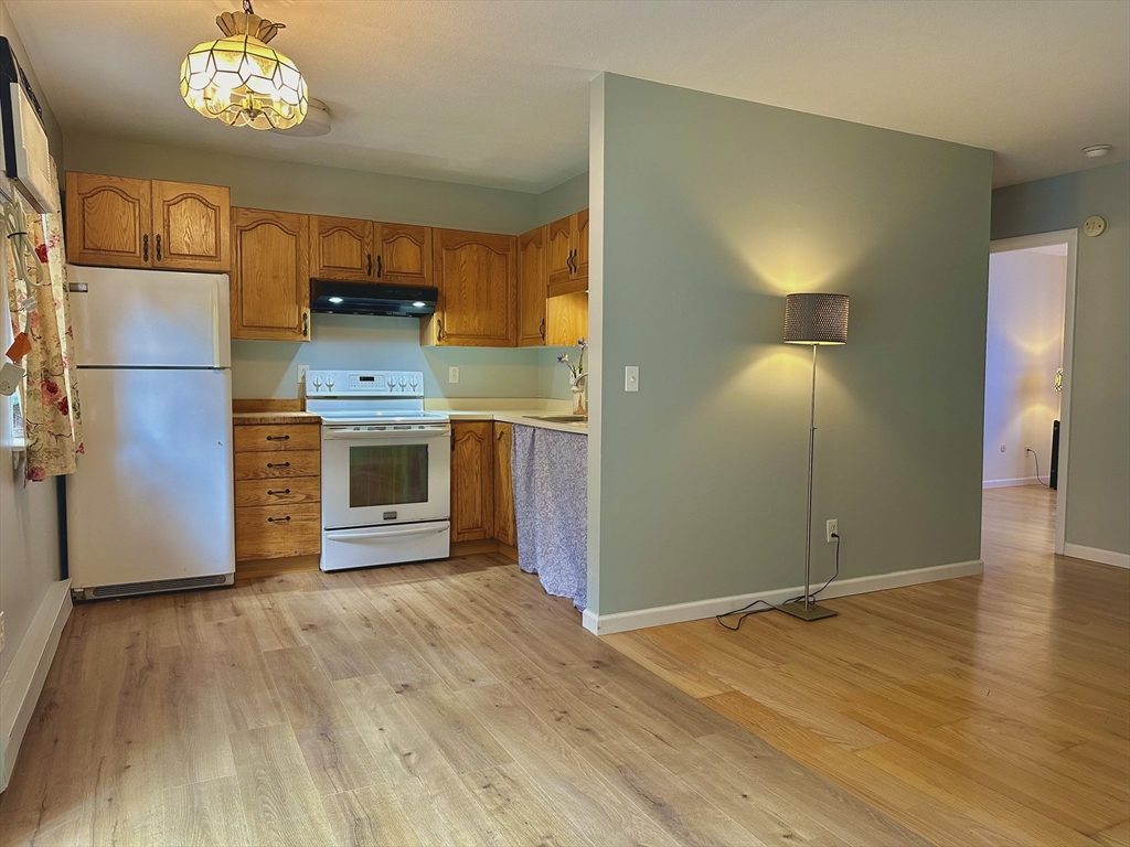 170 East Hadley Road, Unit 11 Amherst, MA 01002 - Photo 7 of 16 a view of a kitchen with a sink cabinets and wooden floor