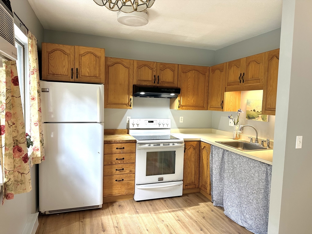 170 East Hadley Road, Unit 11 Amherst, MA 01002 - Photo 8 of 16 a kitchen with stainless steel appliances granite countertop a refrigerator a stove and a sink