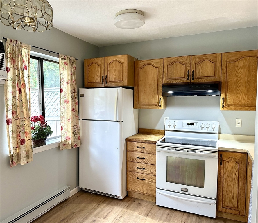 170 East Hadley Road, Unit 11 Amherst, MA 01002 - Photo 9 of 16 a kitchen with a refrigerator and a stove