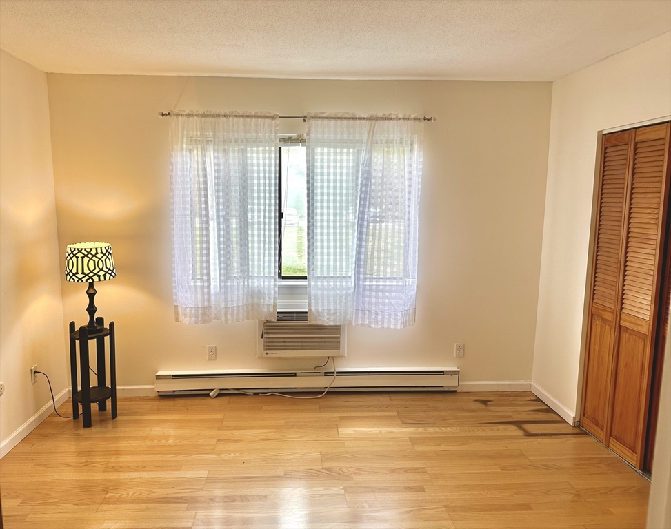 170 East Hadley Road, Unit 11 Amherst, MA 01002 - Photo 10 of 16 a view of empty room with wooden floor
