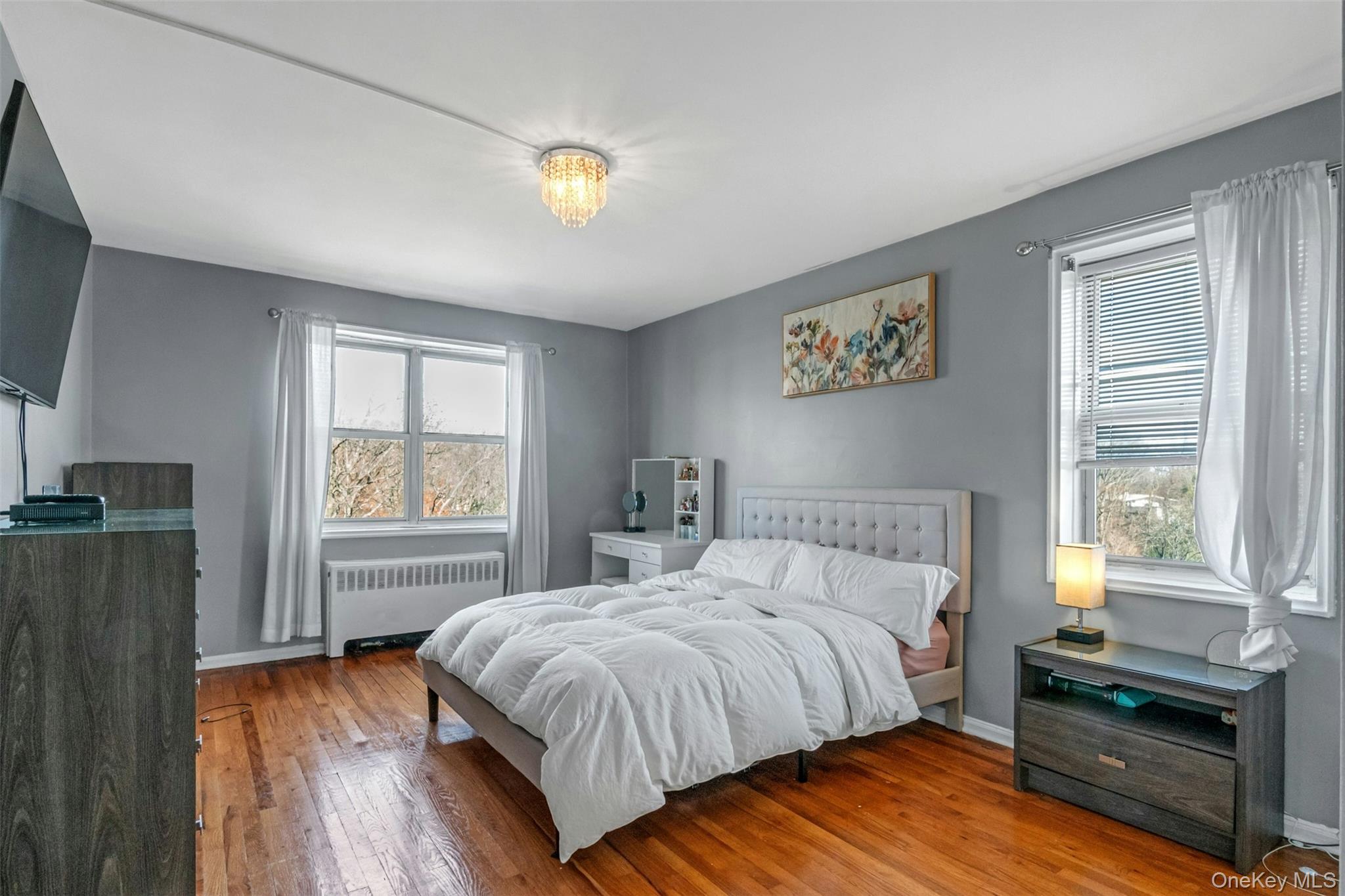 1234 Midland Avenue, Unit 5F Bronxville, NY 10708 - Photo 9 of 13 a bedroom with a bed and a window