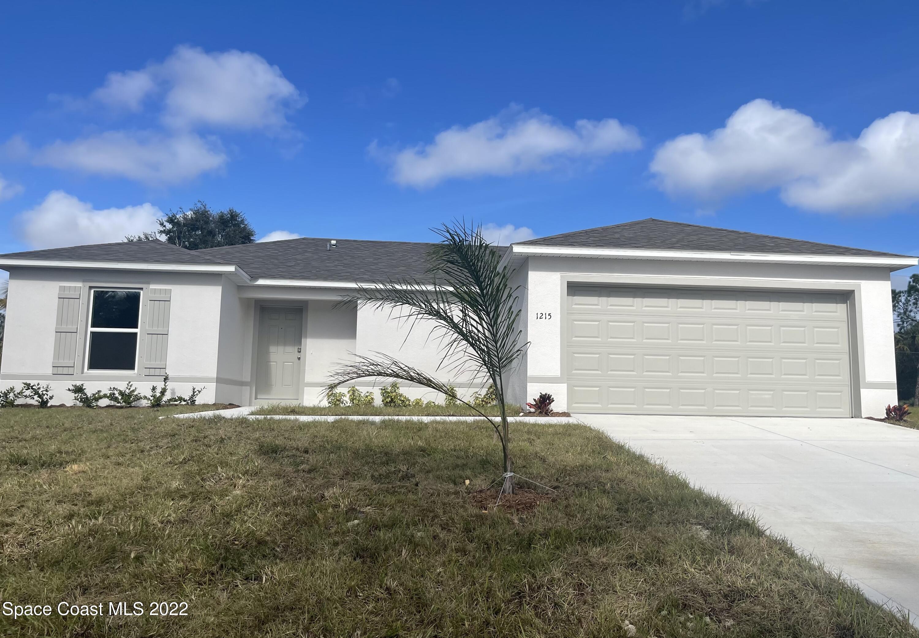 1215 Hastings Road Southwest Palm Bay, FL 32908 - Photo 1 of 16 front view of house with a yard