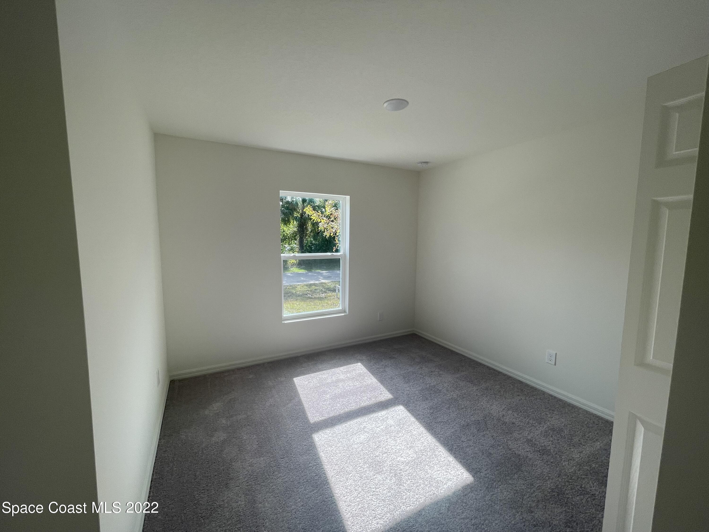 1215 Hastings Road Southwest Palm Bay, FL 32908 - Photo 13 of 16 an empty room with windows