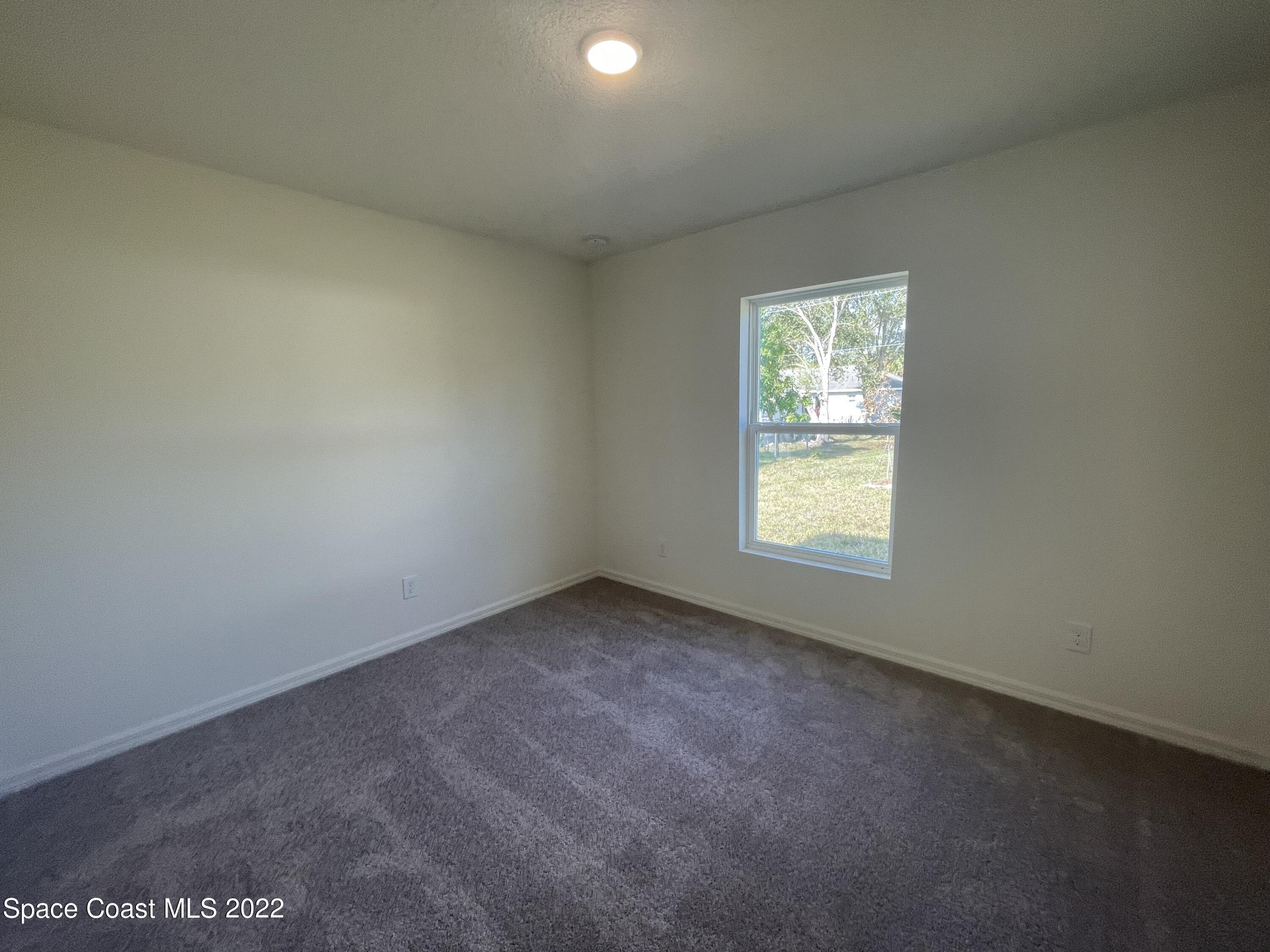 1215 Hastings Road Southwest Palm Bay, FL 32908 - Photo 15 of 16 an empty room with a window