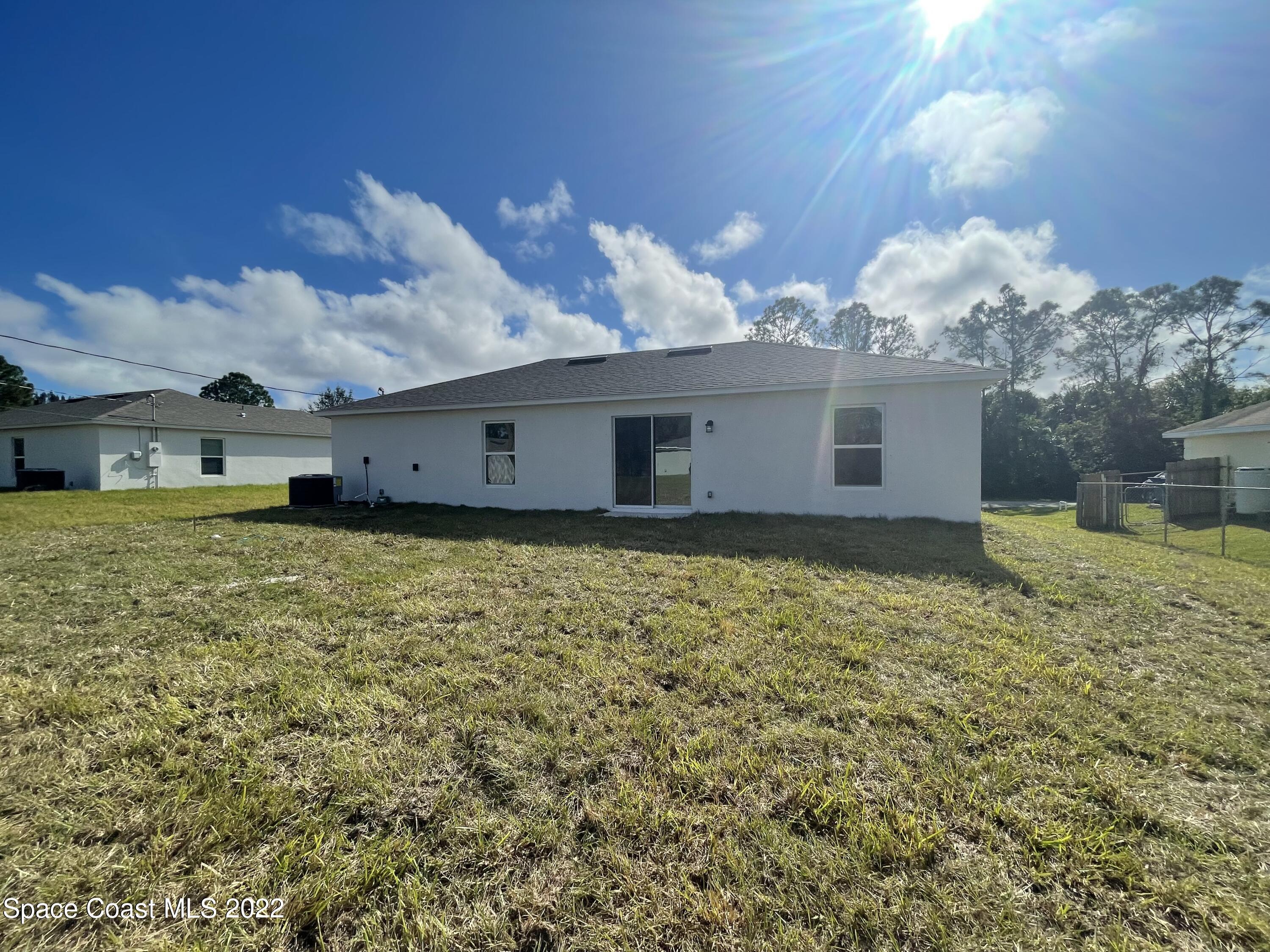1215 Hastings Road Southwest Palm Bay, FL 32908 - Photo 16 of 16 a view of a house with a yard