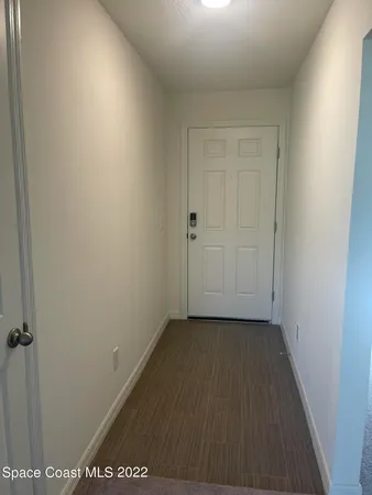 an empty room with wooden floor