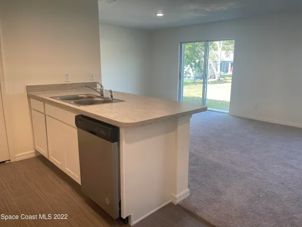 a kitchen with a sink and a window