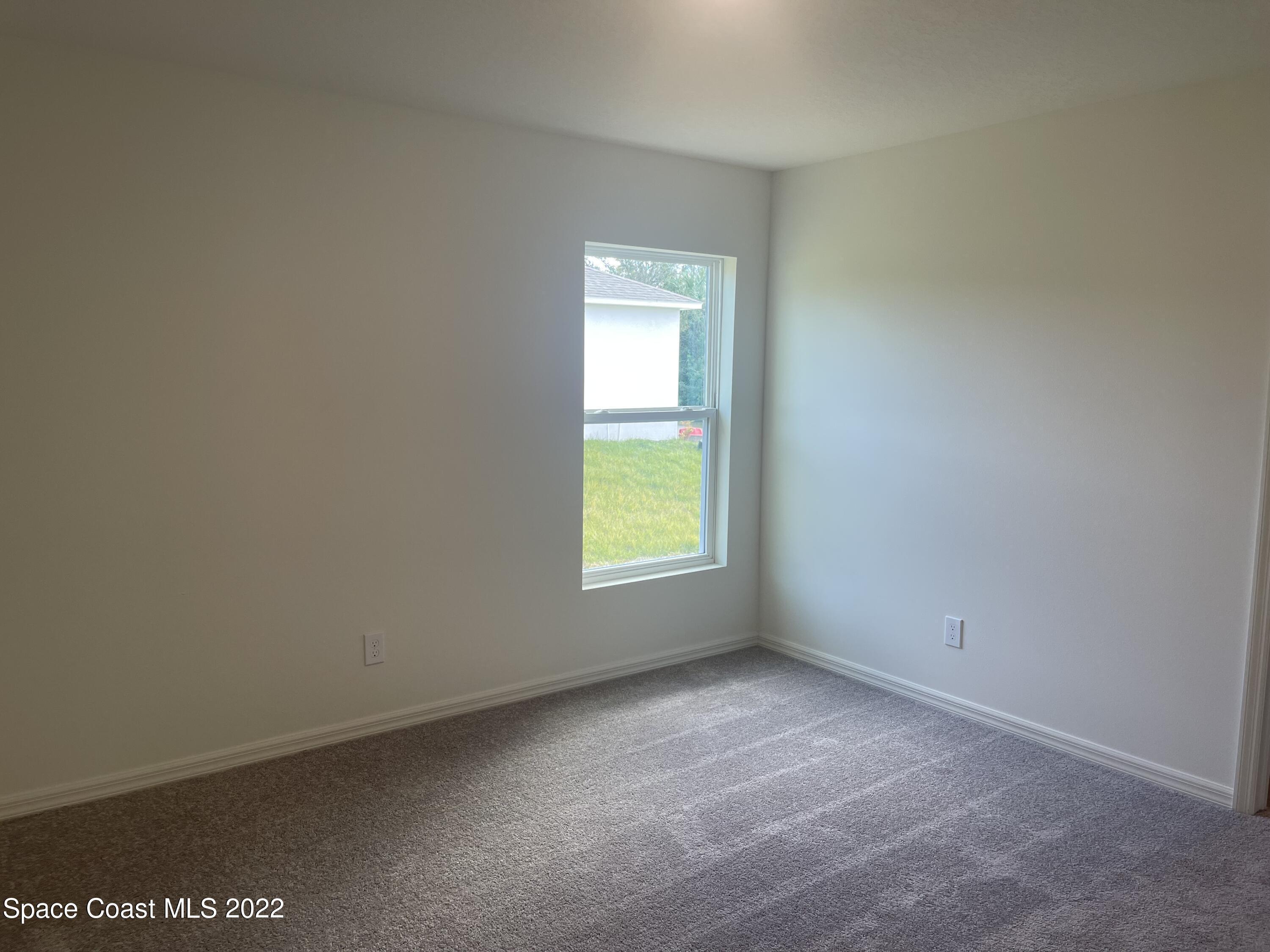 1215 Hastings Road Southwest Palm Bay, FL 32908 - Photo 8 of 16 a view of an empty room with a window