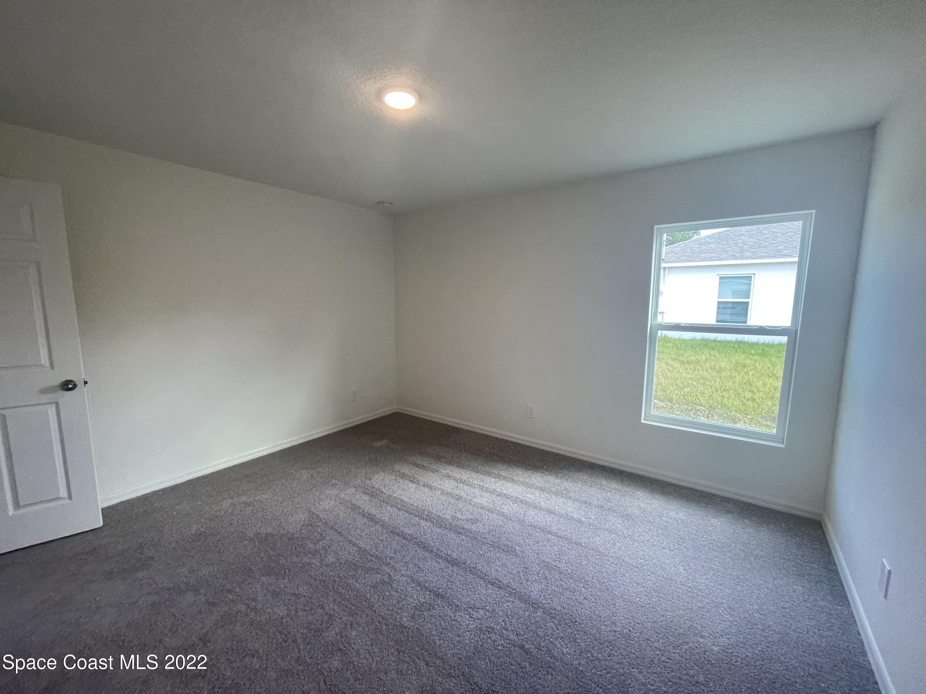 1215 Hastings Road Southwest Palm Bay, FL 32908 - Photo 9 of 16 an empty room with a window