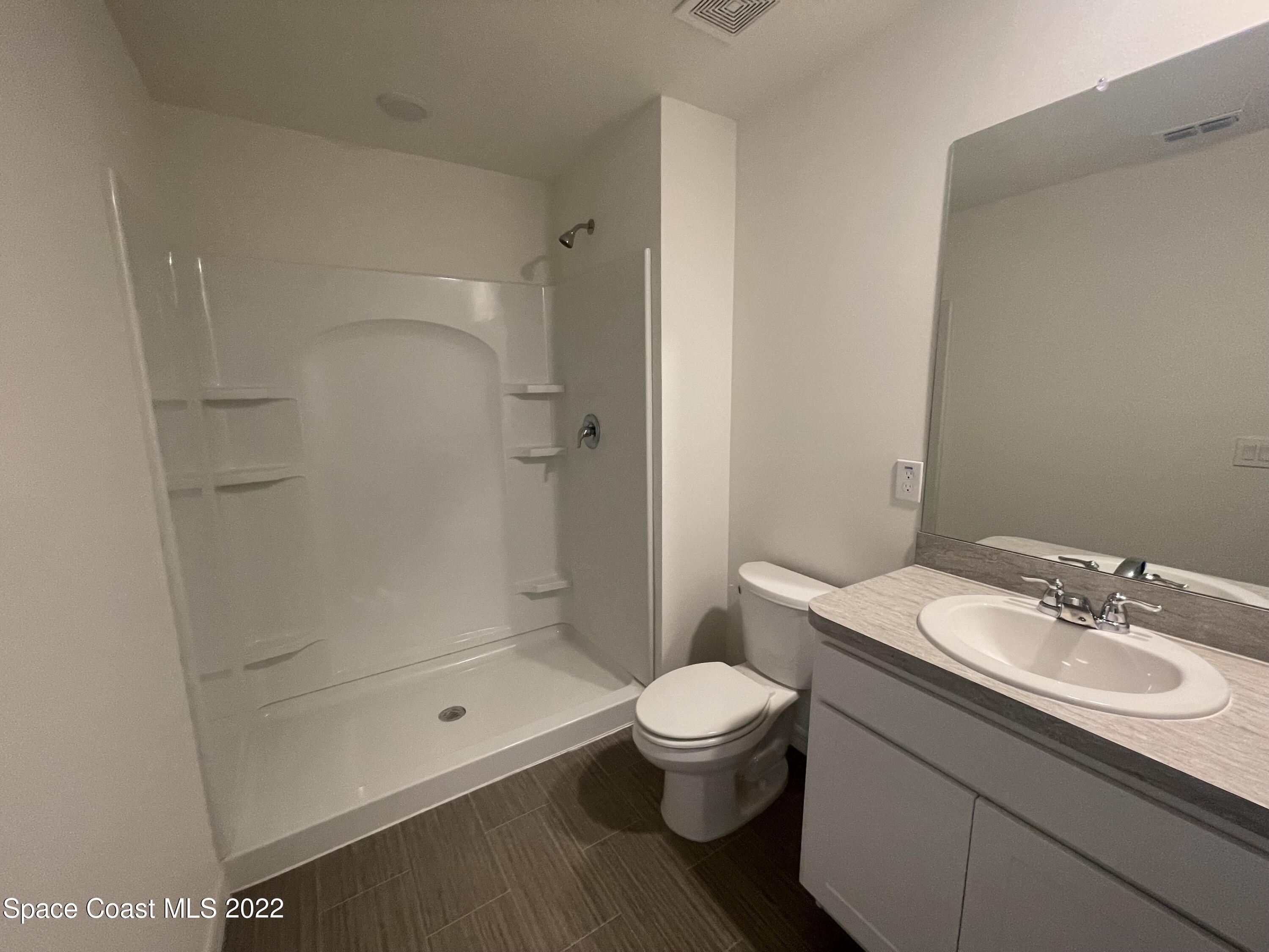 1215 Hastings Road Southwest Palm Bay, FL 32908 - Photo 10 of 16 a bathroom with a sink toilet and shower