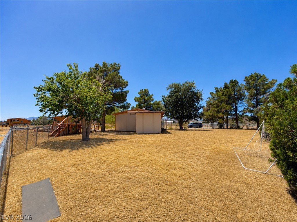1611 West Blosser Ranch Road Pahrump, NV 89060 - Photo 20 of 25 A spacious backyard with mature trees provides ample room for outdoor activities.
