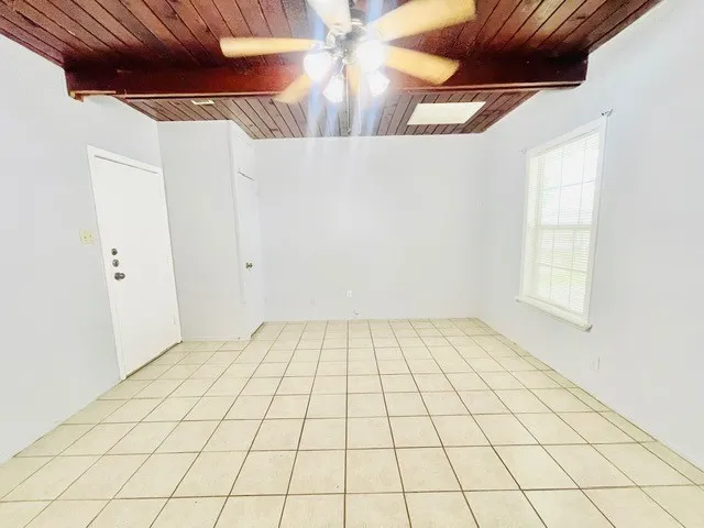 a view of a room & chandelier fan