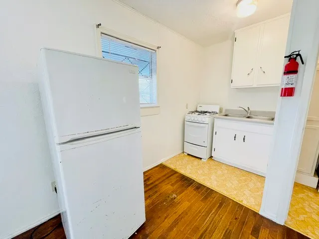 a view of a livingroom with wooden floor and a ceiling fan