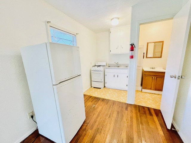 4518 Nicholson Street Corpus Christi, TX 78415 - Photo 29 of 32 a kitchen with a refrigerator and a sink