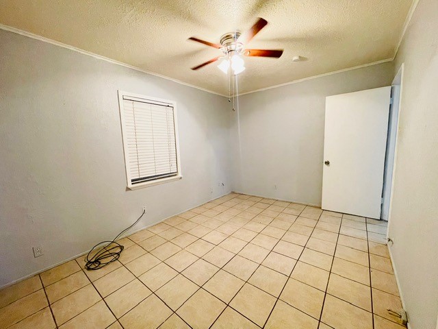4518 Nicholson Street Corpus Christi, TX 78415 - Photo 10 of 32 an empty room with windows and fan