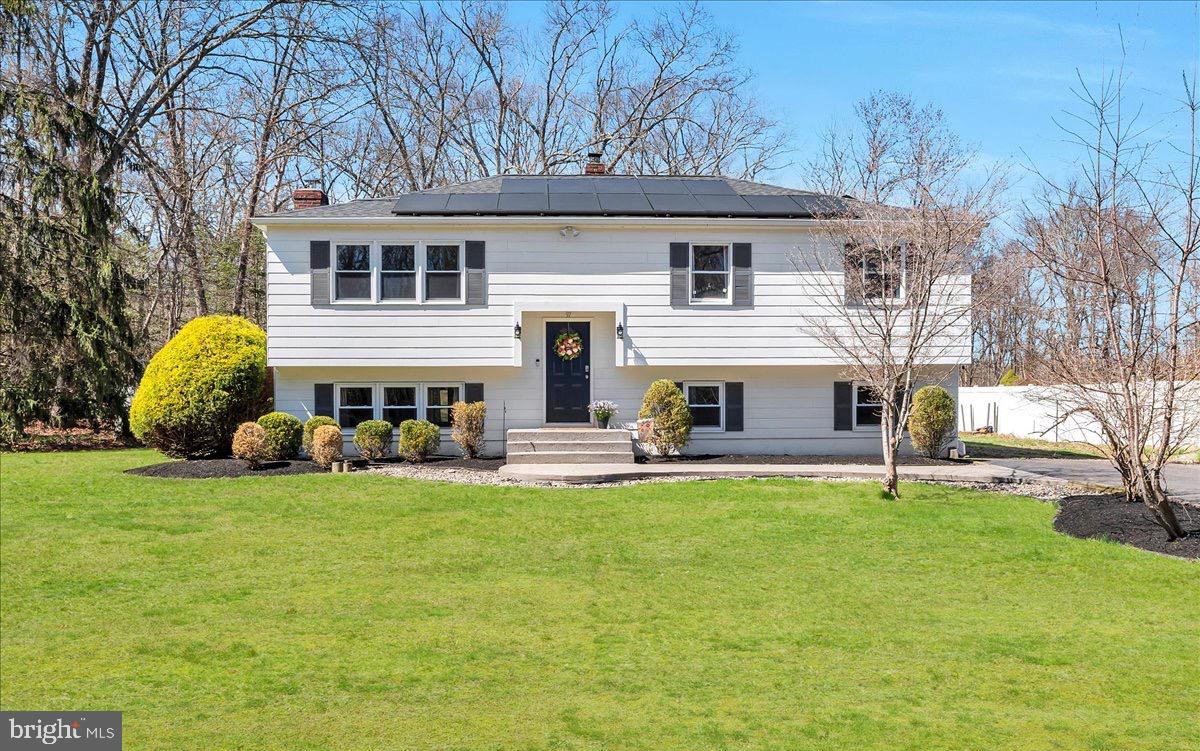 a view of a house with a yard and sitting area