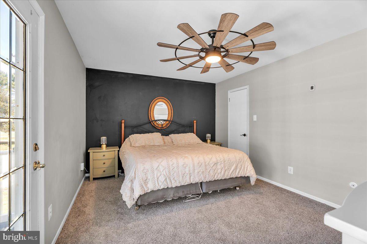 97 3 Bridge Road Shamong, NJ 08088 - Photo 15 of 45 a bedroom with a bed and a chandelier