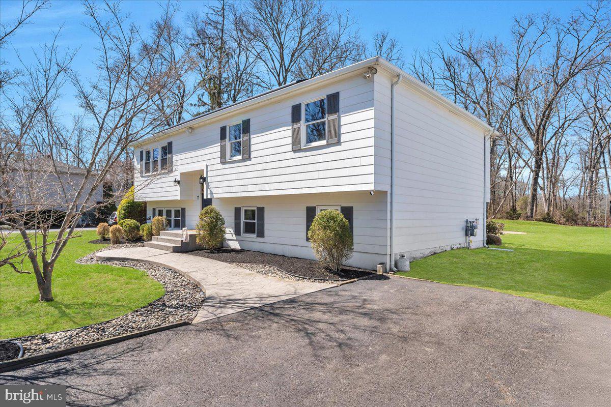 97 3 Bridge Road Shamong, NJ 08088 - Photo 3 of 45 a front view of a house with a yard and garage