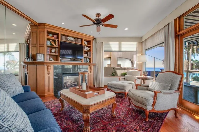 a living room with fireplace a flat screen tv and a table
