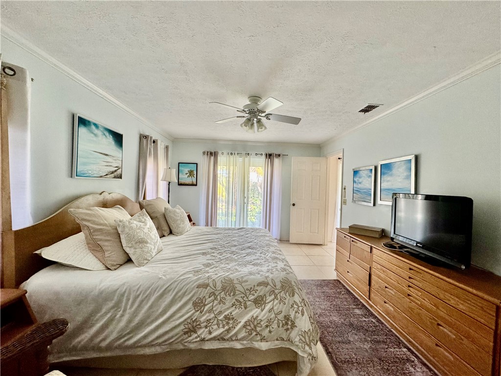 1946 Surfside Terrace Vero Beach, FL 32963 - Photo 21 of 36 a bedroom with a bed and a flat screen tv
