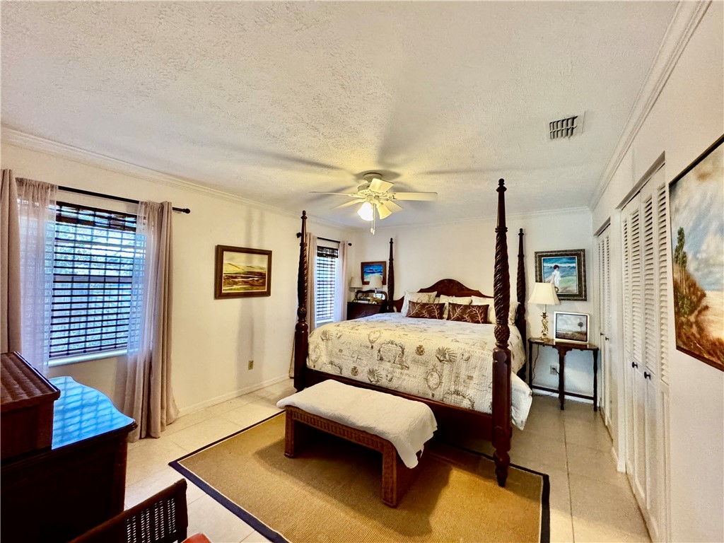 1946 Surfside Terrace Vero Beach, FL 32963 - Photo 25 of 36 a bedroom with a bed window and couch